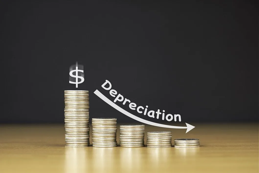 Depreciation sign with stacked coins