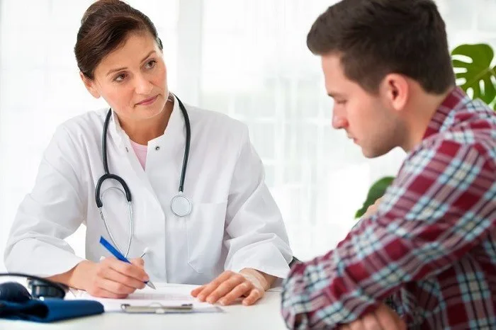 Female doctor consulting with elderly male patient