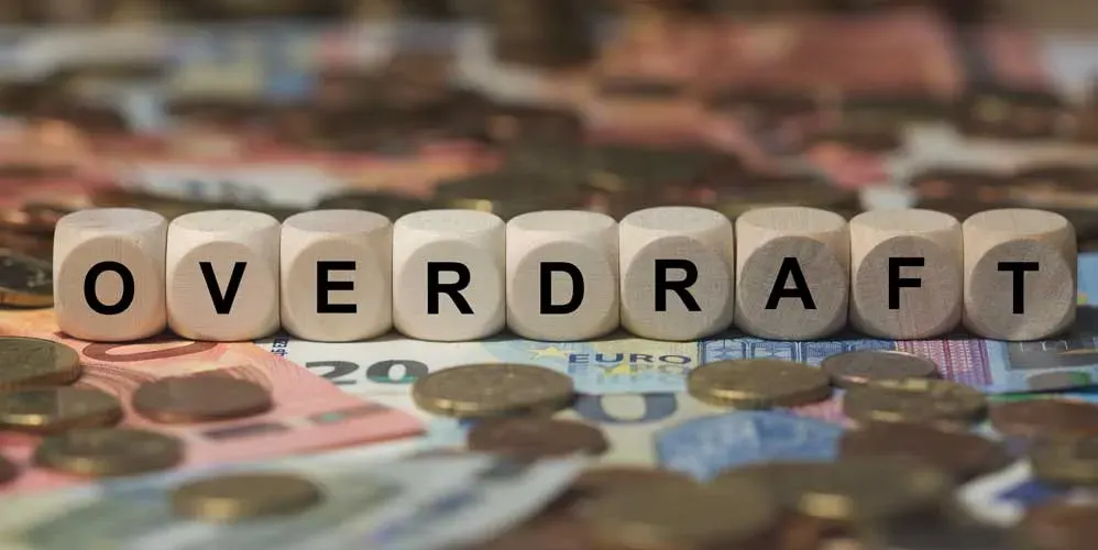 Person holding icons labeled Overdraft